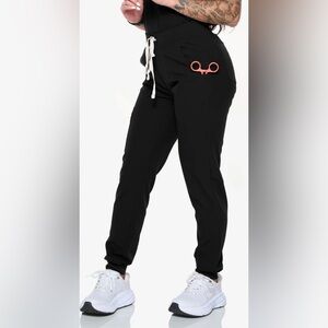 4 code next scrub joggers, two scrub tops and one figs scrubs joggers